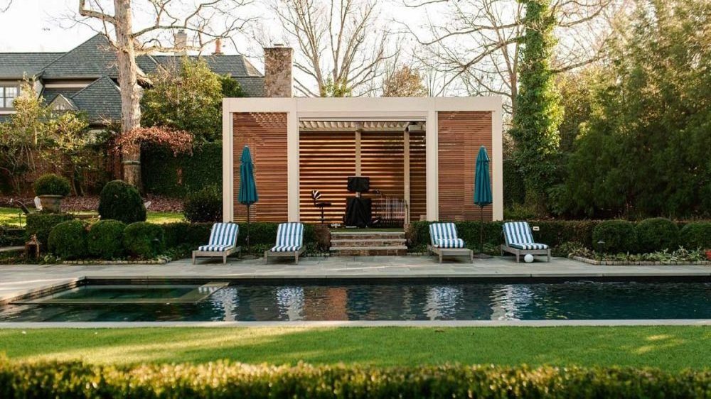 Pergola structure over a home golf simulation and clubhouse space