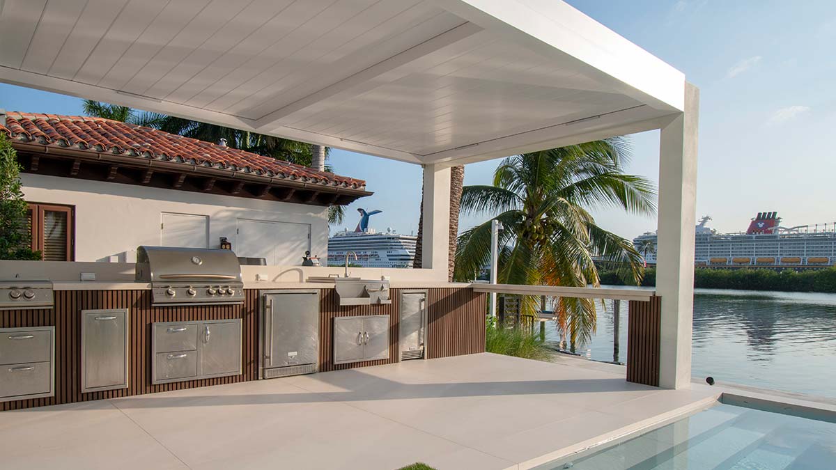 Luxury modern outdoor kitchen under a pergola structure